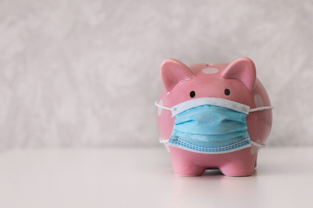 Pink piggy bank wearing a mask representing health savings account HSA benefits
